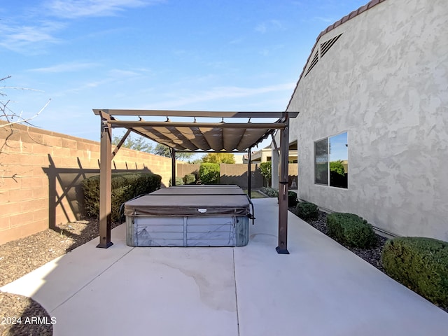 view of patio / terrace featuring a pergola and a hot tub