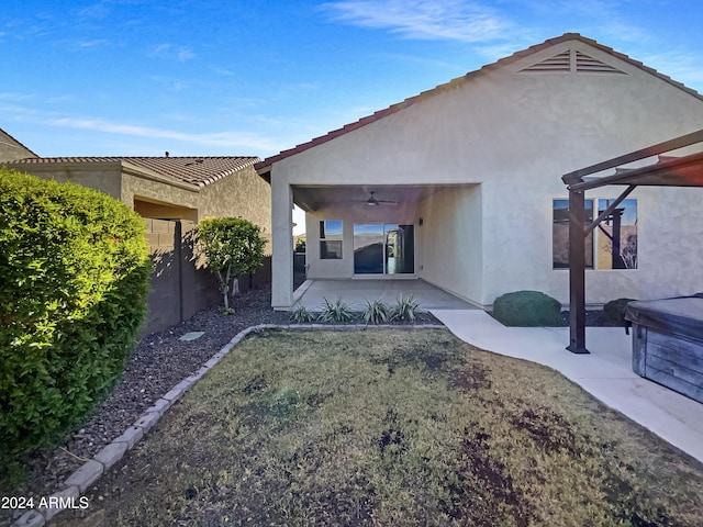 back of property with a patio and ceiling fan