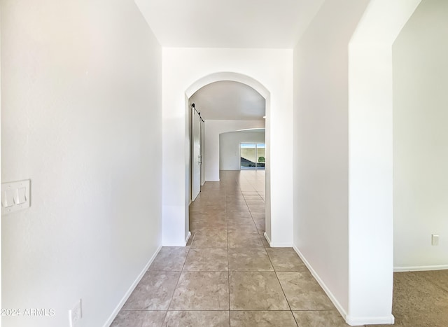 corridor featuring light tile patterned flooring