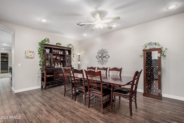 dining space with ceiling fan, wood finished floors, visible vents, and baseboards