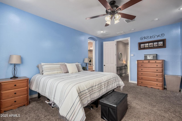 bedroom featuring arched walkways, carpet flooring, ceiling fan, and visible vents