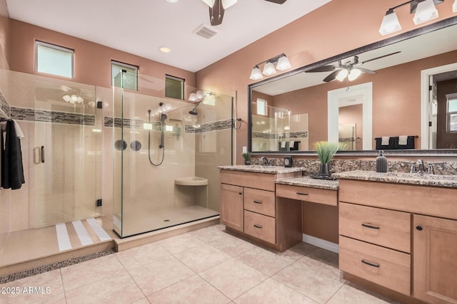 full bathroom with ceiling fan, a stall shower, vanity, and tile patterned floors