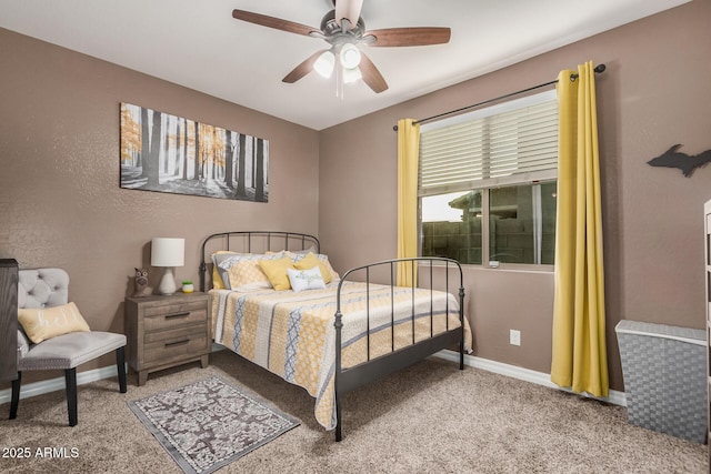 bedroom with a ceiling fan, carpet flooring, a textured wall, and baseboards