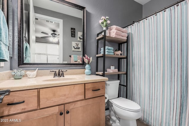 bathroom with ceiling fan, vanity, and toilet