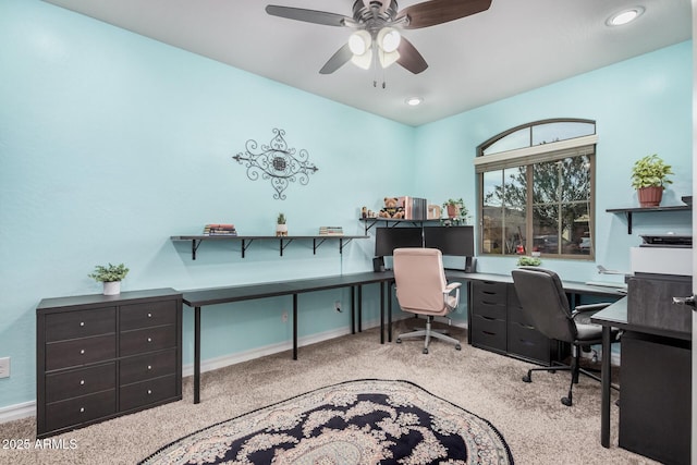 home office featuring carpet floors, baseboards, and a ceiling fan