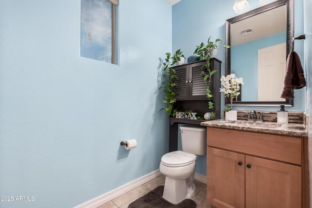 half bathroom featuring visible vents, toilet, vanity, baseboards, and tile patterned floors