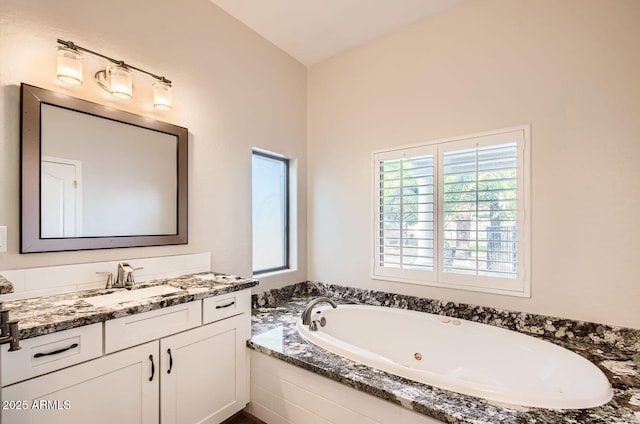 bathroom featuring vanity and tiled bath