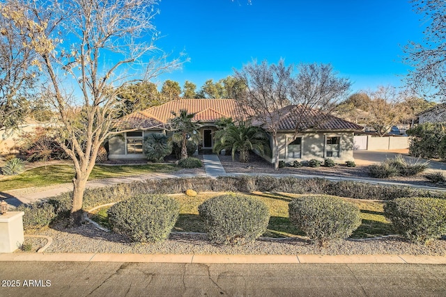 mediterranean / spanish house with a front yard