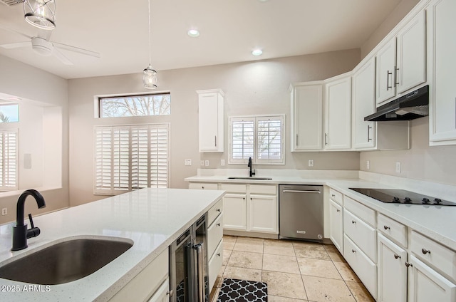 kitchen featuring stainless steel dishwasher, black electric stovetop, sink, and white cabinets