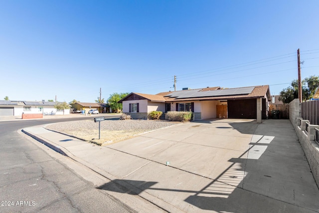 ranch-style house with solar panels