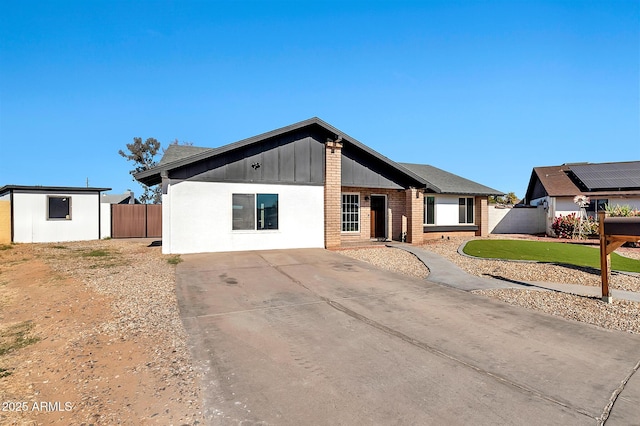 ranch-style house with a front lawn and a storage unit