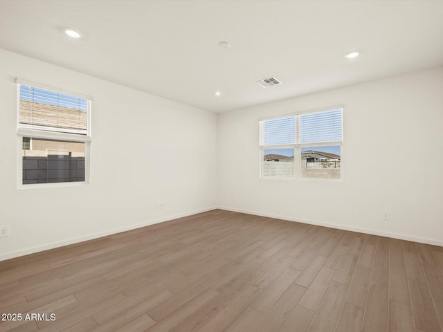 empty room with light hardwood / wood-style floors