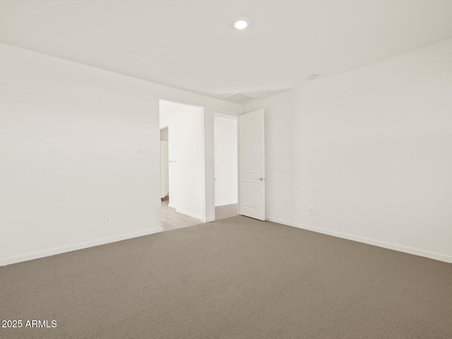 unfurnished room with light colored carpet