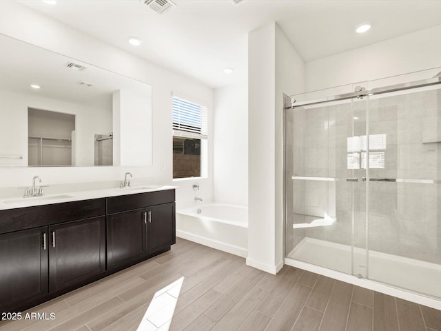 bathroom featuring separate shower and tub and vanity