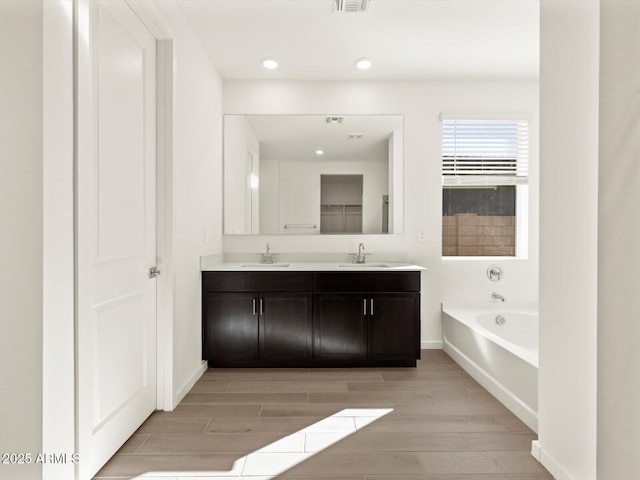 bathroom with vanity and a bathtub