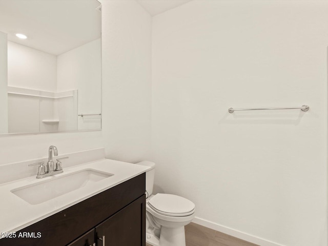 bathroom featuring vanity and toilet