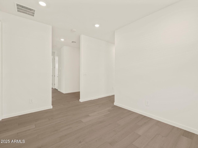 unfurnished room with hardwood / wood-style floors