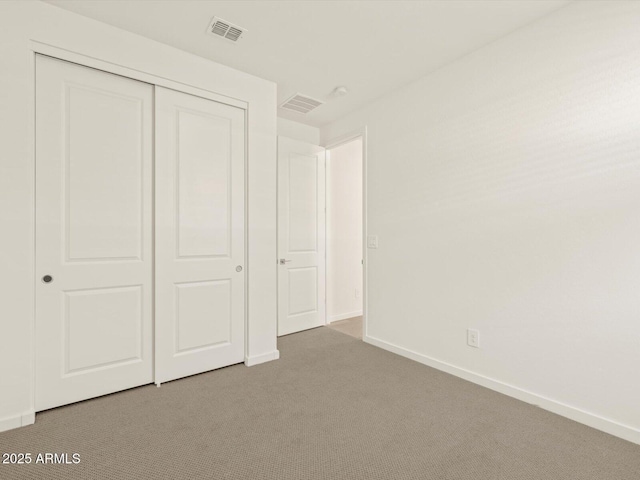 unfurnished bedroom with carpet floors and a closet