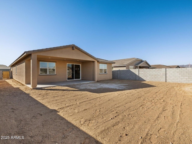 rear view of house with a patio