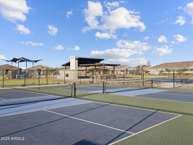 view of tennis court with a playground and basketball court