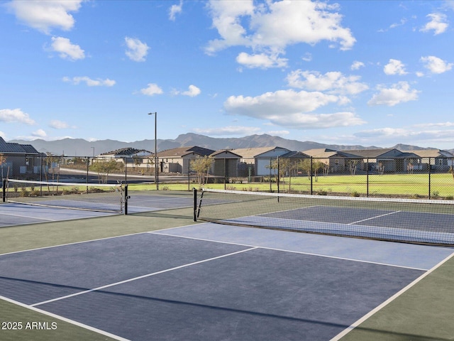 view of tennis court featuring a mountain view