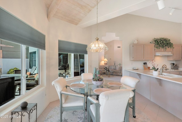 dining room with light tile patterned floors, wood ceiling, sink, beam ceiling, and a notable chandelier