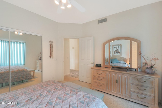 carpeted bedroom featuring a closet and ceiling fan