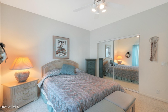 bedroom featuring light colored carpet, a closet, and ceiling fan