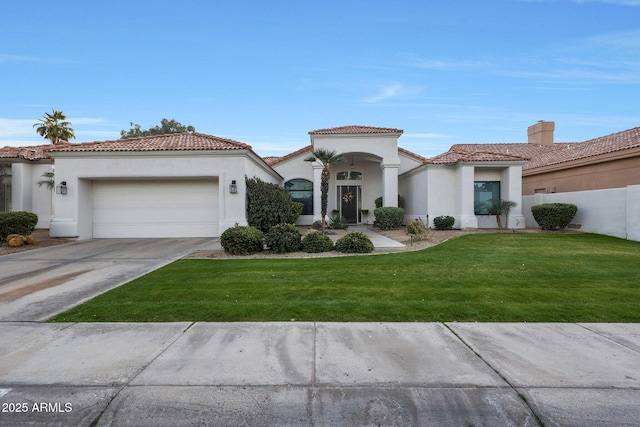 mediterranean / spanish-style house with a garage and a front lawn