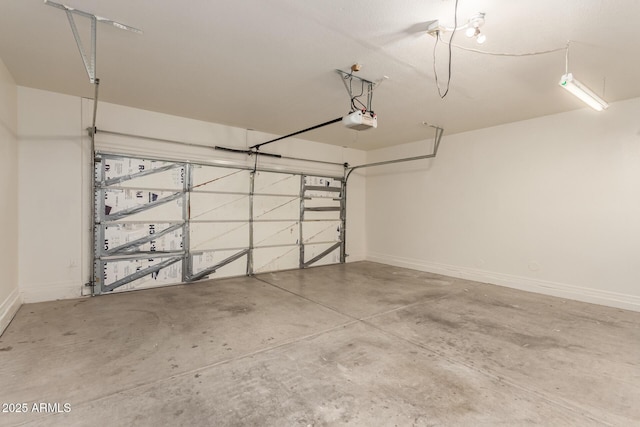 7029 S Golfside Ln, Phoenix, AZ 85042 - garage featuring a garage door opener and baseboards