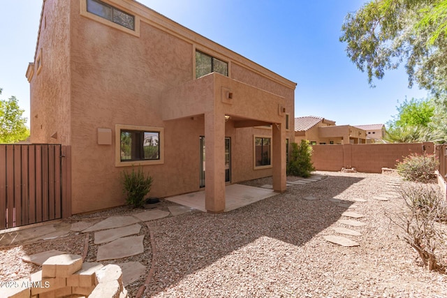 7029 S Golfside Ln, Phoenix, AZ 85042 - rear view of property with a fenced backyard, stucco siding, a patio area, and a gate