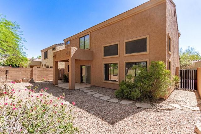 7029 S Golfside Ln, Phoenix, AZ 85042 - rear view of house featuring stucco siding and a patio