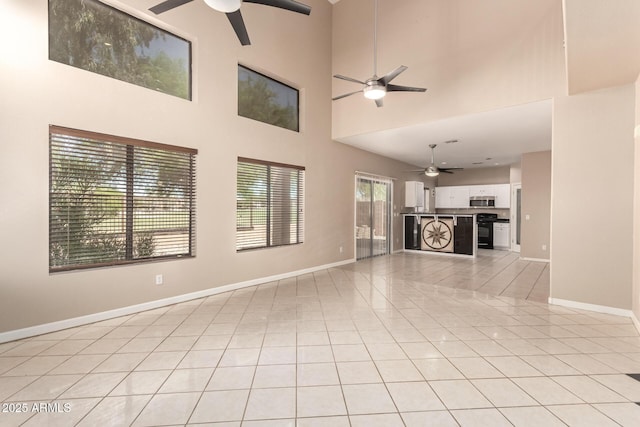 7029 S Golfside Ln, Phoenix, AZ 85042 - unfurnished living room featuring ceiling fan, light tile patterned flooring, and a high ceiling