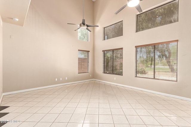 7029 S Golfside Ln, Phoenix, AZ 85042 - unfurnished room featuring a ceiling fan, light tile patterned floors, a towering ceiling, and a smoke detector