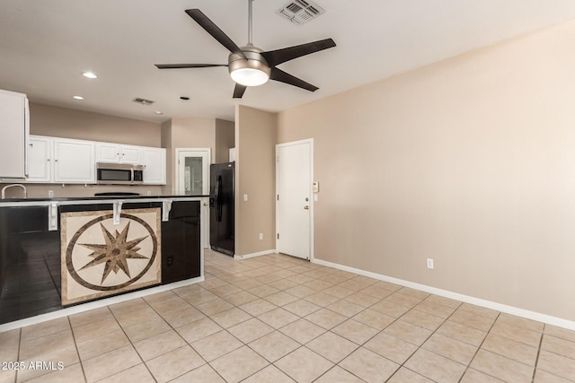 7029 S Golfside Ln, Phoenix, AZ 85042 - kitchen featuring stainless steel microwave, freestanding refrigerator, a ceiling fan, a peninsula, and white cabinets