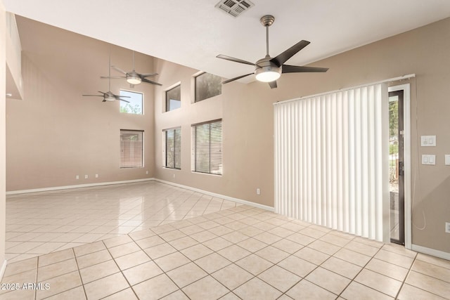 7029 S Golfside Ln, Phoenix, AZ 85042 - empty room featuring ceiling fan, light tile patterned flooring, and a towering ceiling