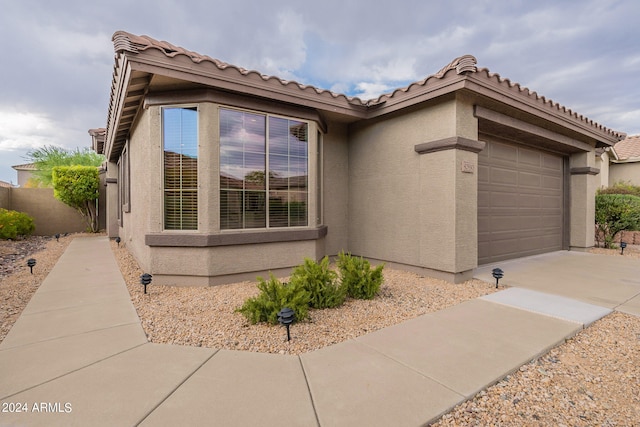 view of side of property with a garage