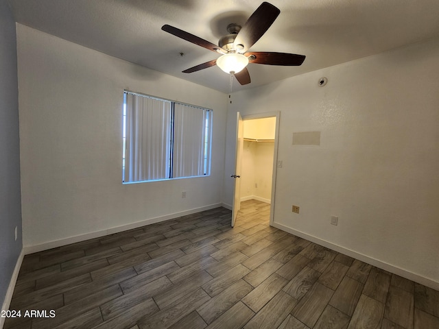 spare room with dark hardwood / wood-style floors and ceiling fan