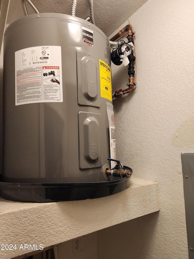 details featuring a textured ceiling and electric water heater