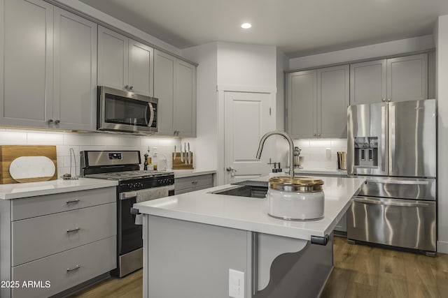 kitchen with light countertops, gray cabinetry, appliances with stainless steel finishes, and recessed lighting