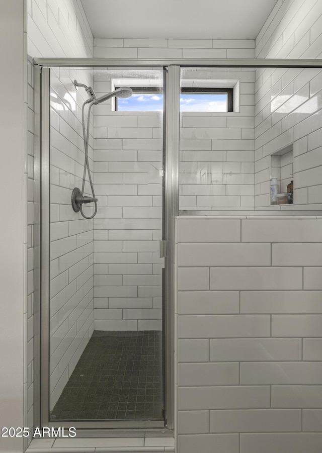 bathroom featuring a healthy amount of sunlight and a stall shower