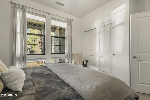 bedroom with visible vents and a closet