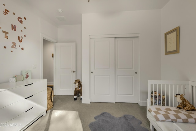 bedroom with visible vents, carpet, and a closet