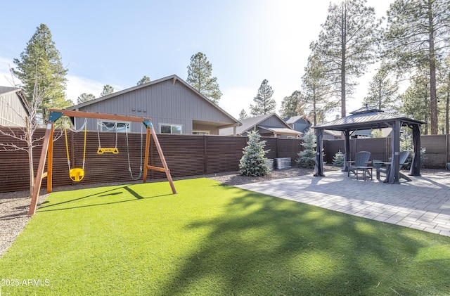 view of yard featuring a playground, a patio, a gazebo, and a fenced backyard