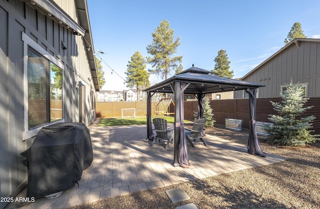 view of patio featuring a gazebo, a fenced backyard, and a grill