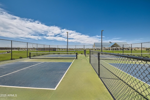 view of sport court featuring fence