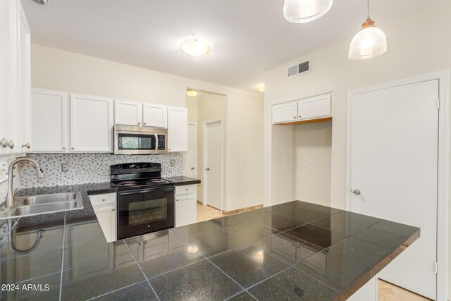 kitchen featuring black appliances, pendant lighting, kitchen peninsula, sink, and white cabinetry