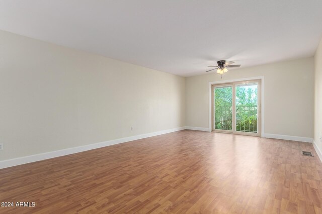 spare room featuring light hardwood / wood-style flooring and ceiling fan