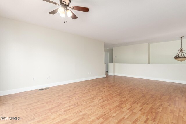 spare room featuring light wood-type flooring and ceiling fan