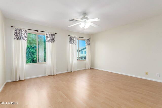 interior space with light wood-type flooring, sink, and ceiling fan